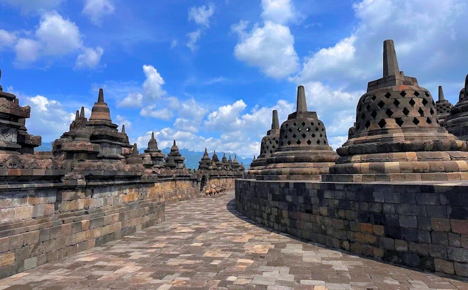 A temple complex with tiered stone structures and a paved pathway. 1
