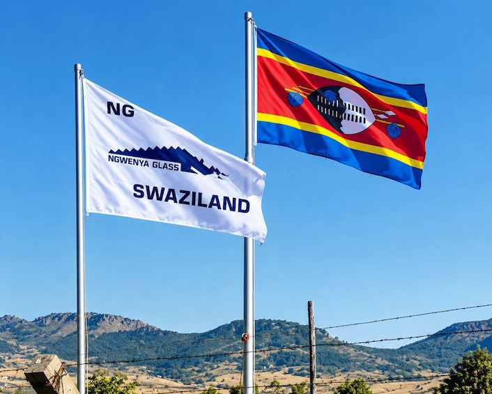Two flags, one with 'NG' and 'NGWENYA GLASS SWAZILAND' and another with a blue, red, and yellow design. 2