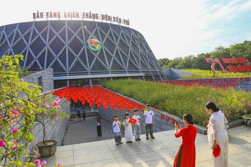 A stadium with a large entrance and red seats. 5