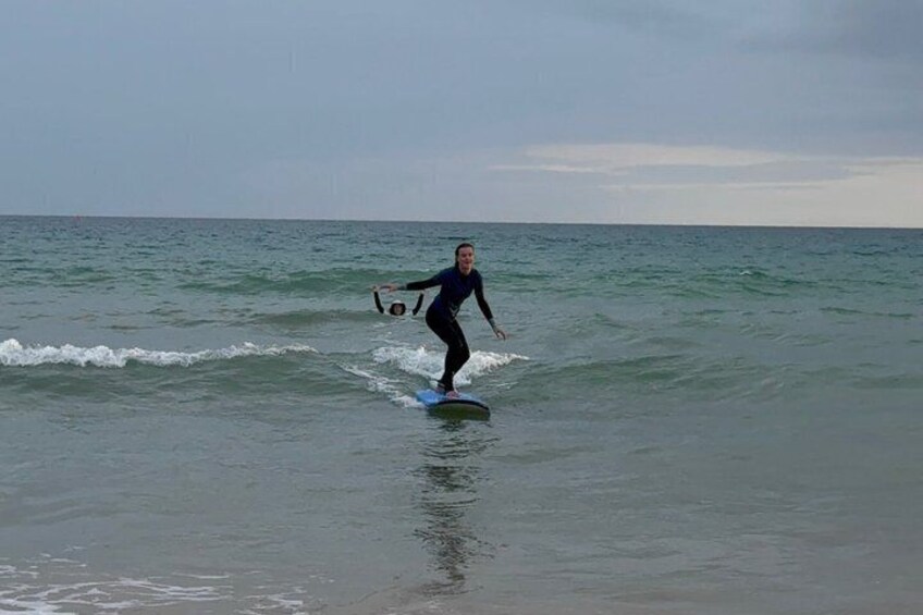 A person surfing on a wave in the ocean. 4