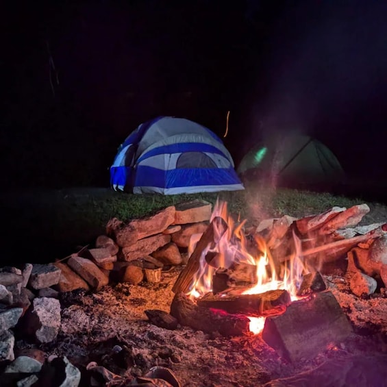 A campfire with tents in the background. 3