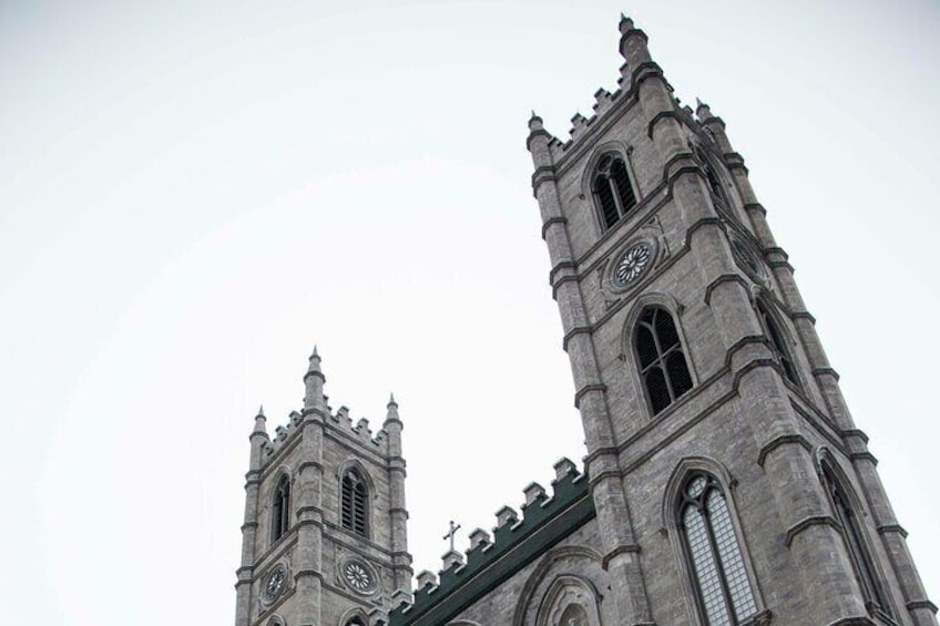 A tall, Gothic-style church with two towers and a clock on each. 3