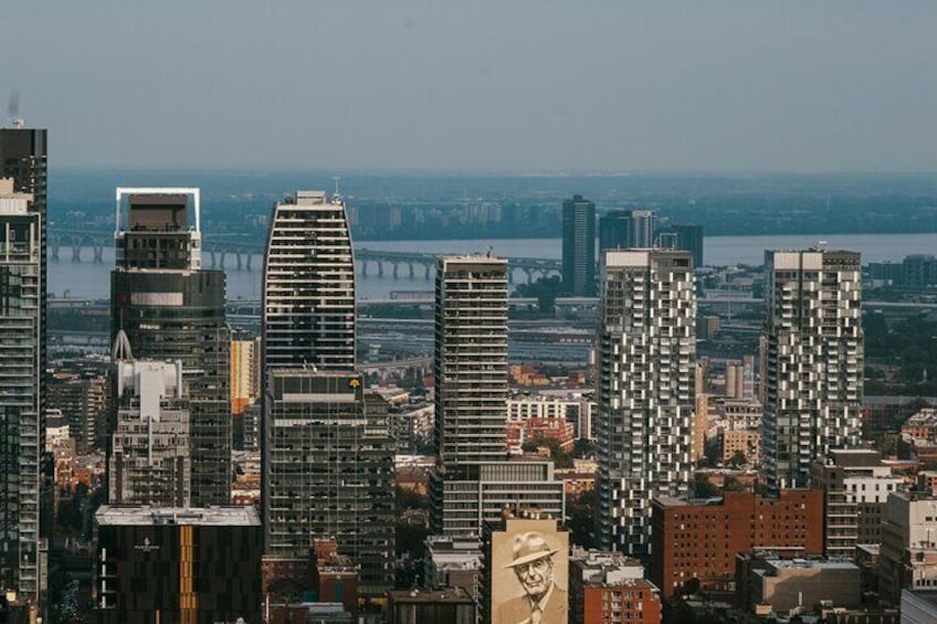 A cityscape with modern high-rise buildings, a river, and a bridge in the background. 5