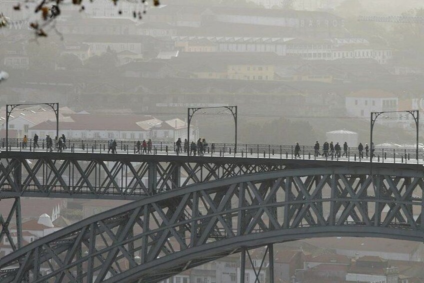 A metal bridge with pedestrians walking across. 4