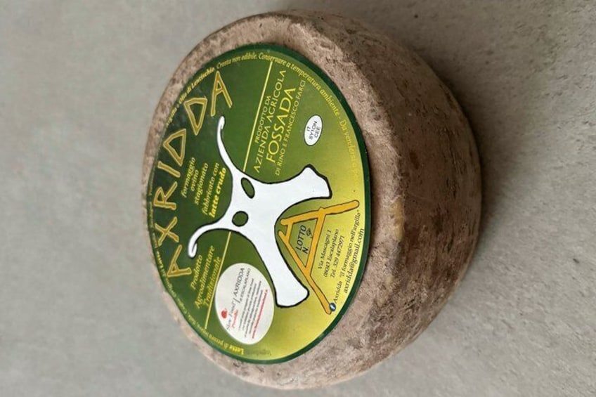A round cheese with a label. 2