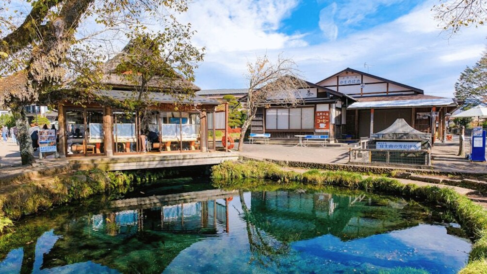 A traditional Japanese building with a pond in front. 4
