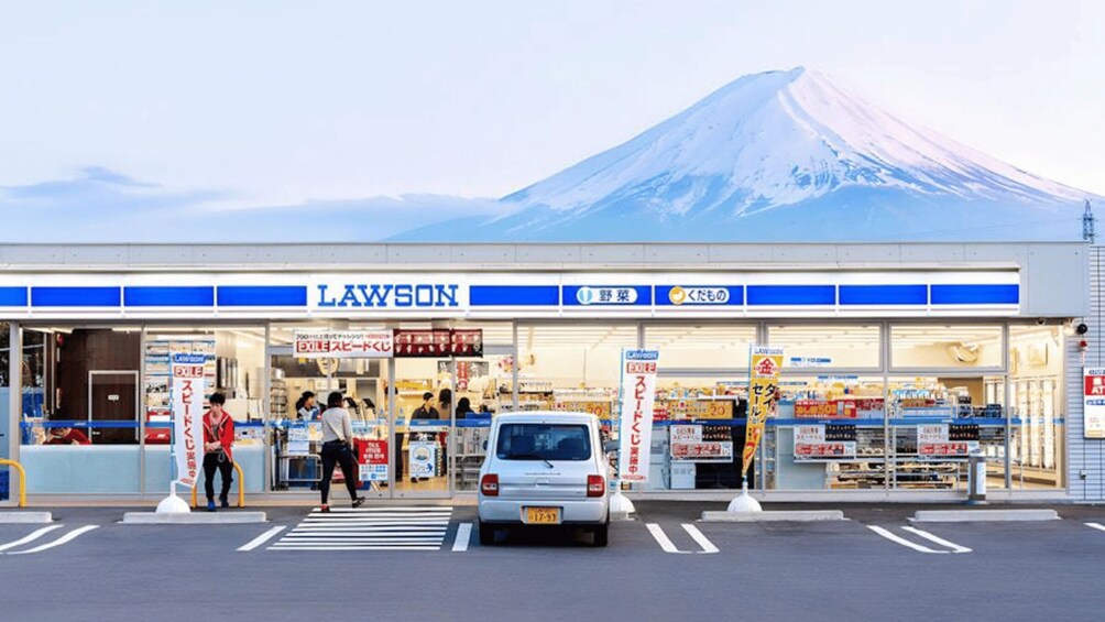 A Lawson convenience store with a mountain in the background. 1
