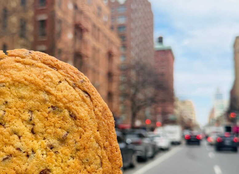 A muffin in focus with a blurred city street in the background. 3