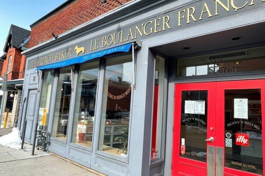 A storefront with a red door and a blue awning, labeled 'The French Baker.' 5