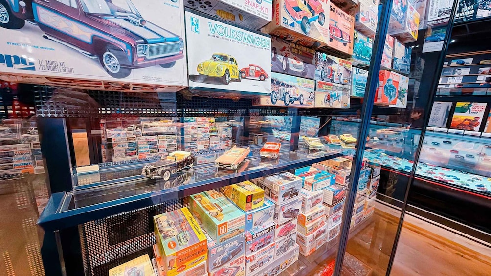 A model car shop with various model kits and cars on display. 3