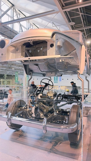 A car's interior and engine exposed in a manufacturing setting. 2