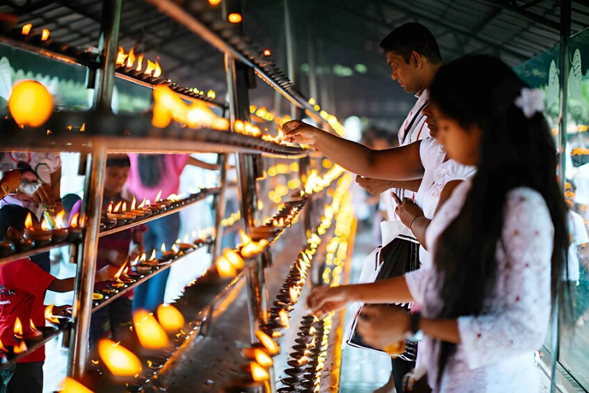People lighting oil lamps in a temple. 5