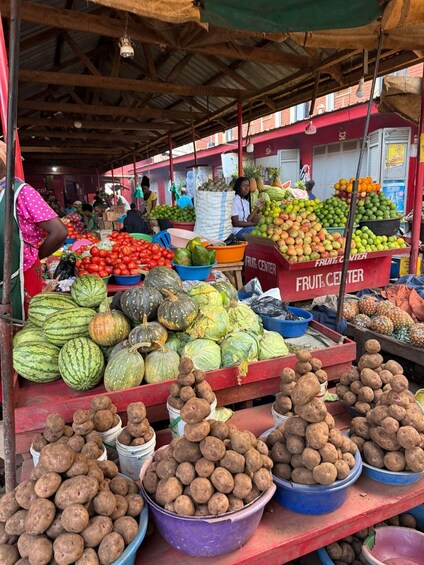 A fruit and vegetable market with various produce displayed in bins and baskets. 3