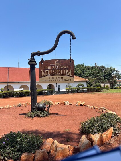 A sign for The Railway Museum with a curved metal structure in front. 4
