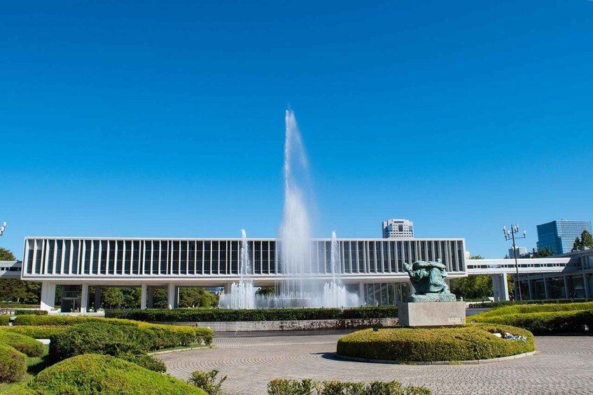 A modern building with a fountain and a statue in front. 5