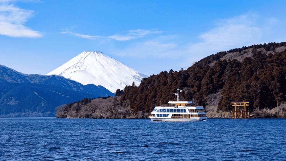 A boat on a lake with a snow-capped mountain in the background. 4