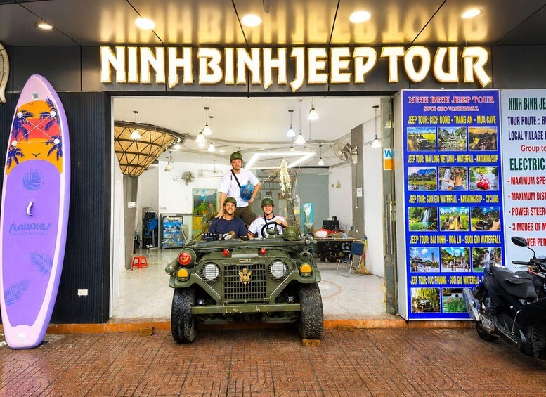 A jeep tour service with a signboard listing tour routes and activities. 3