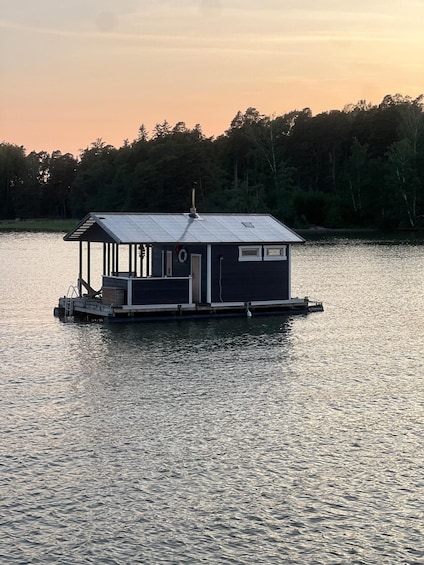 A houseboat on a calm lake at sunset. 1