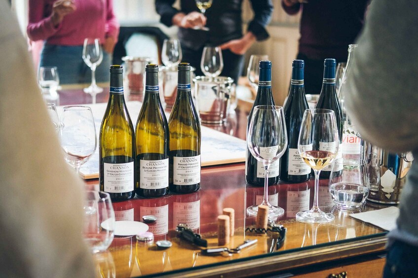 A wine tasting event with bottles and glasses on a table. 5