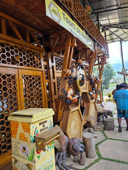 A wooden structure with honeycomb patterns and bee sculptures. 3