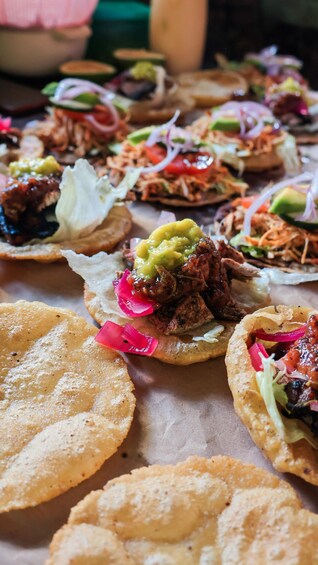 A variety of tacos with different toppings and sauces, served on corn tortillas. 5