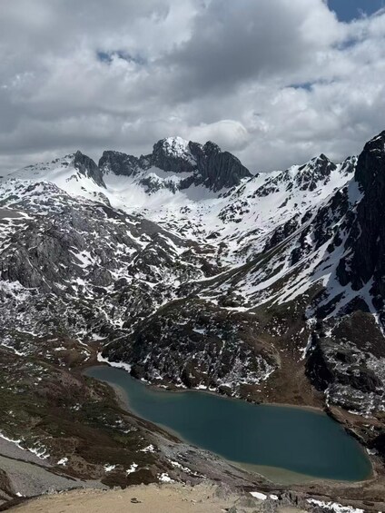 A mountainous landscape with a lake and snow-covered peaks. 2