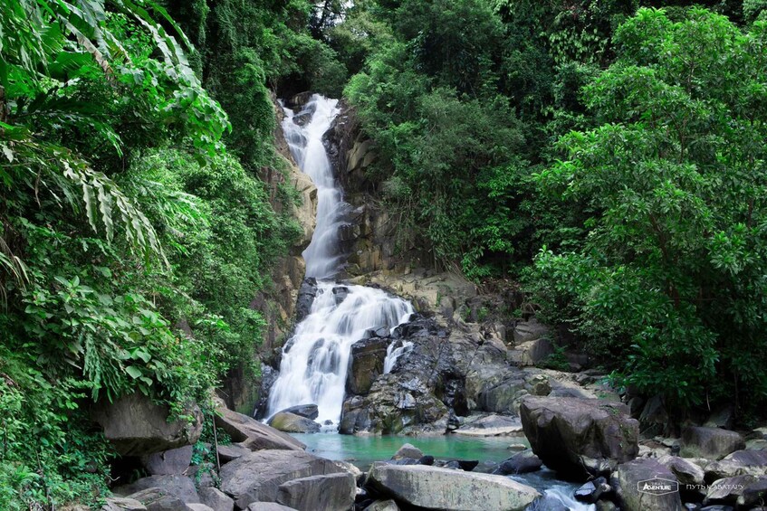 A waterfall surrounded by lush greenery. 2