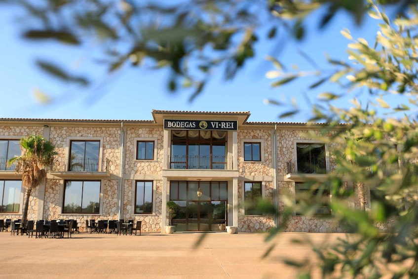 A building with a stone facade and a sign that reads 'BODEGAS VI-REI.' 5