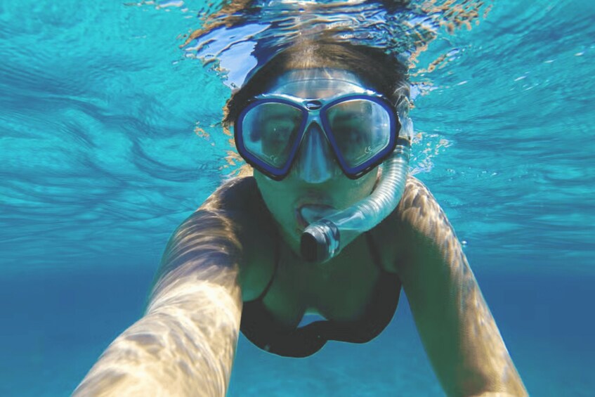 A person snorkeling underwater. 4