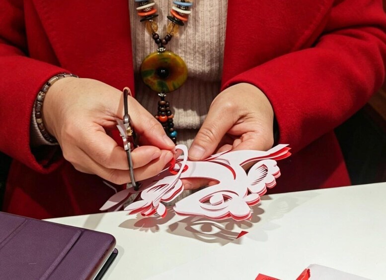 A person cutting paper with scissors. 3