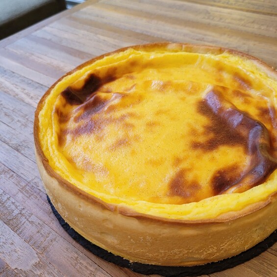 A quiche on a wooden cutting board. 1