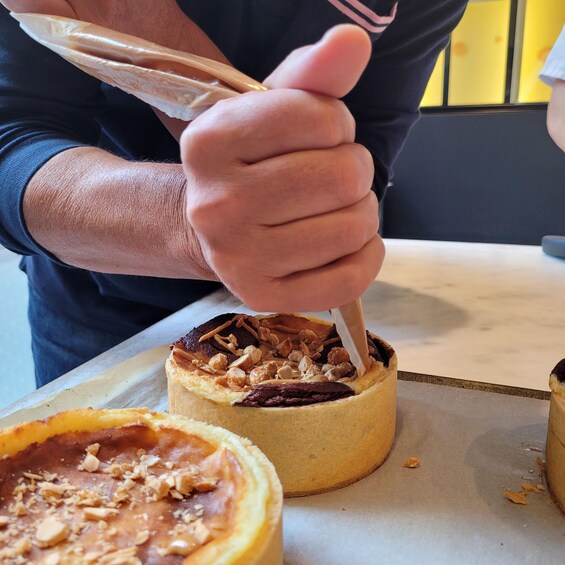 A person holding a pastry with a fork. 3
