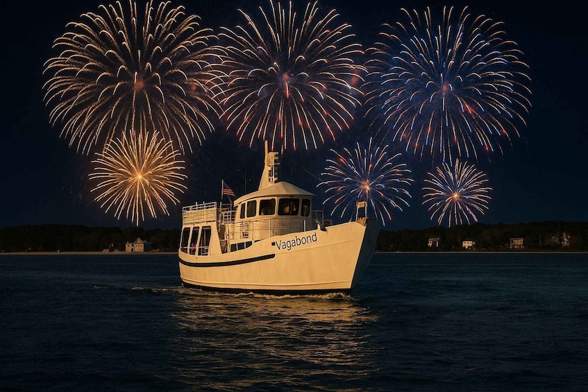A boat named 'Vagabond' on water with fireworks in the background. 5