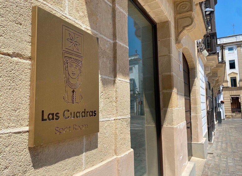 A building with a sign reading 'Las Cuadras Spirit Room.' 2