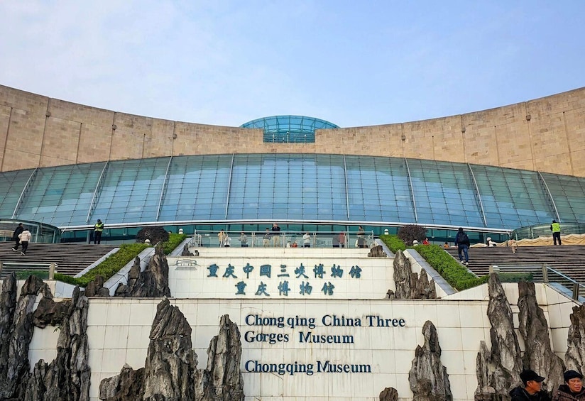 The Chongqing China Three Gorges Museum with a modern glass facade and a stone facade entrance. 1