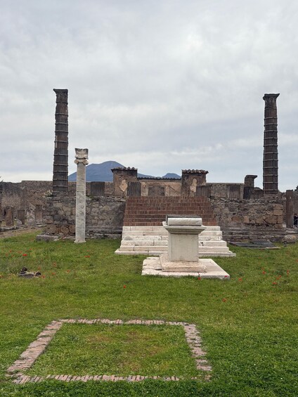 Ancient ruins with stone columns and a stone staircase. 1