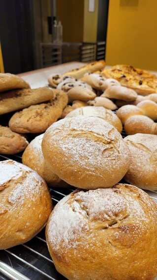 An assortment of breads and pastries on a wire rack. 2