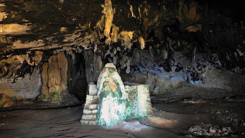 A cave with stalactites and a central ice formation. 4