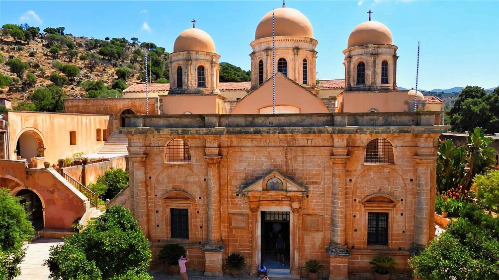 A church with three domes and a bell tower. 5