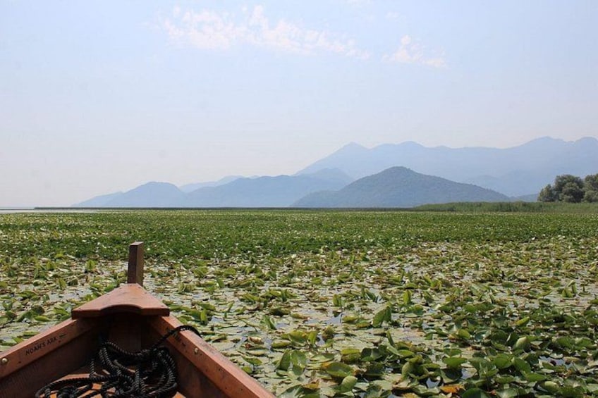 A boat on a lake surrounded by mountains. 3