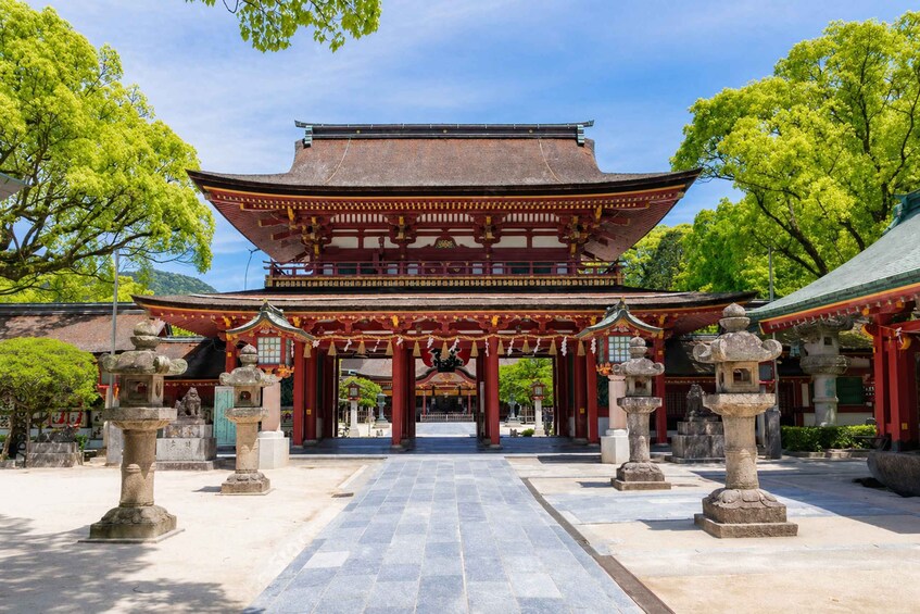 A traditional Japanese temple with a large, ornate gate and stone lanterns. 5