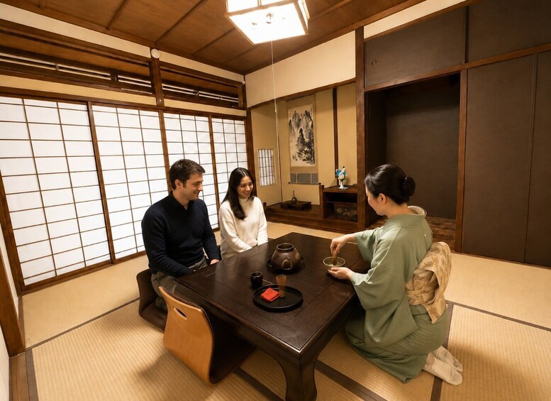 A traditional Japanese room with tatami flooring, a wooden table, and shoji screens. 3