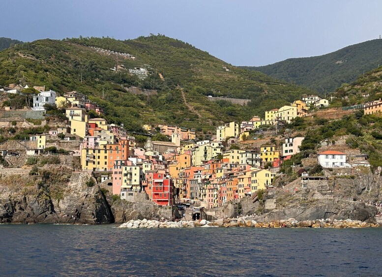 A coastal village with colorful buildings nestled on a hillside. 5