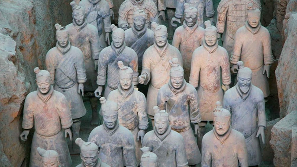 A collection of terracotta soldiers in a formation. 2
