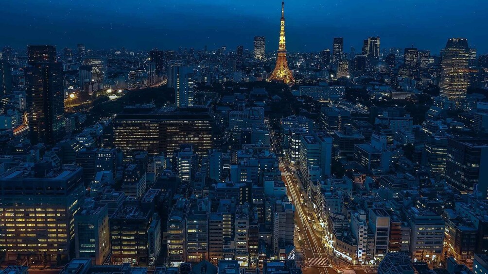 A nighttime cityscape with illuminated buildings and the Eiffel Tower in the center. 3