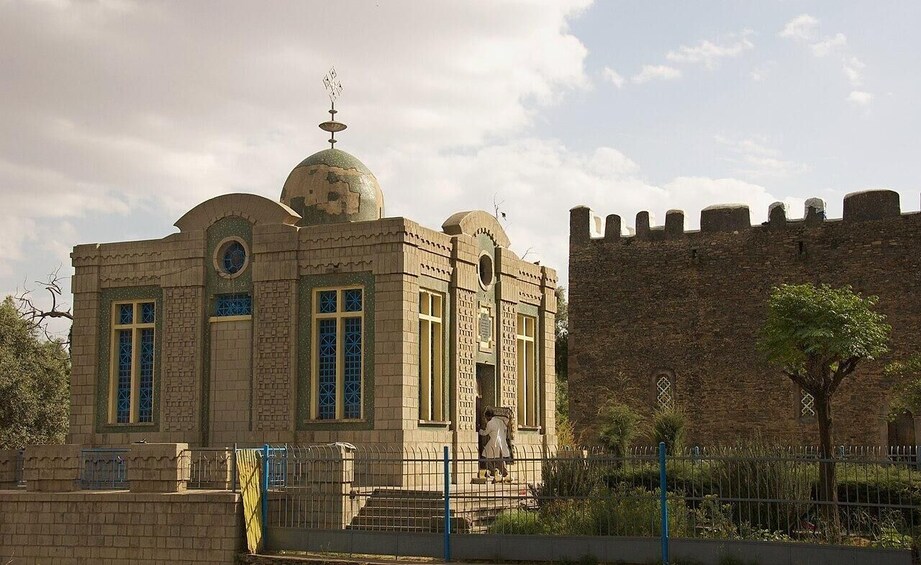 A historic building with a dome and a fortified wall. 3