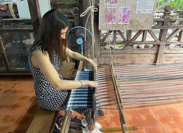A person weaving on a loom. 5