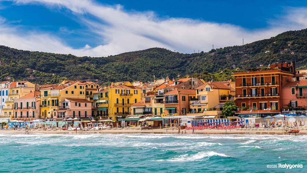 A coastal town with colorful buildings, a beach, and a mountainous backdrop. 3