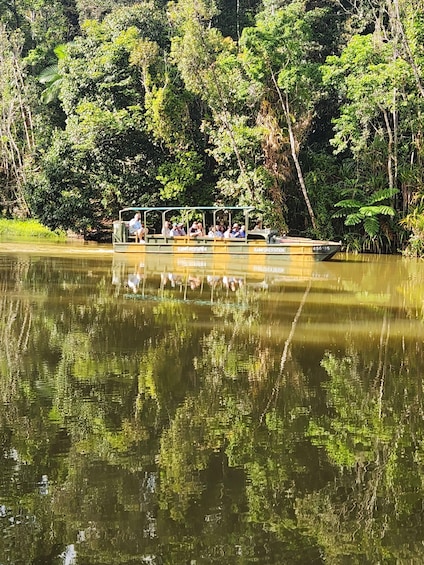 A boat with passengers on a river surrounded by dense greenery. 2