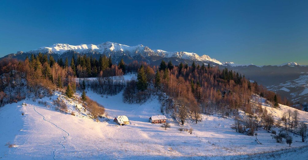 A snow-covered mountain landscape with a clear sky. 4